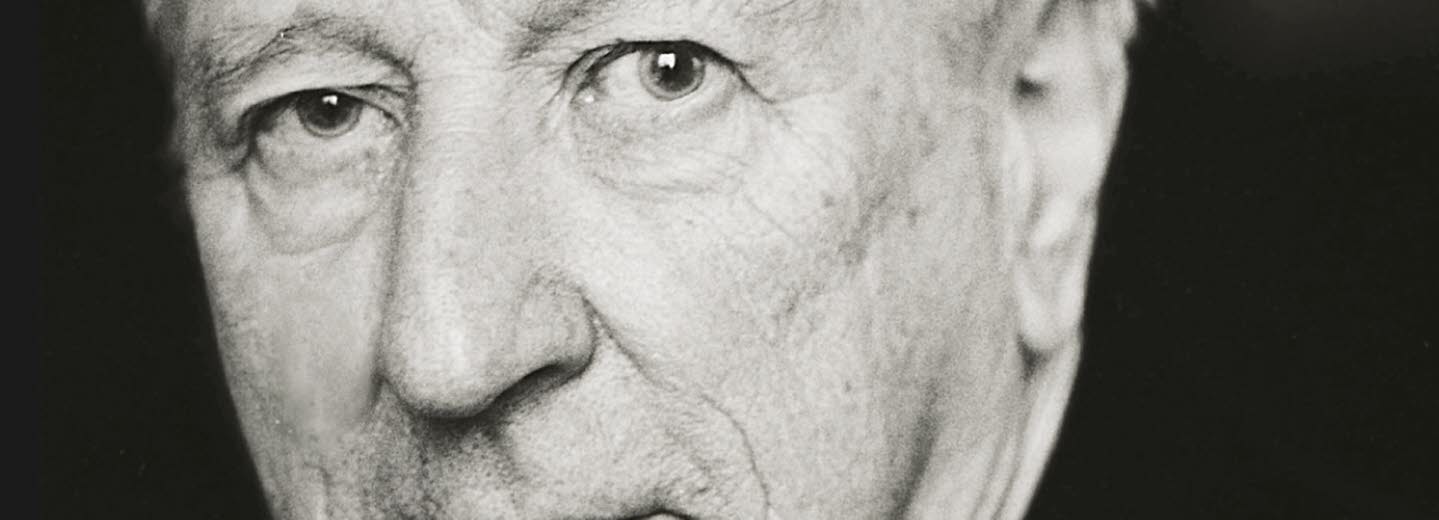 Book cover: A  black and white portrait of a man in a white shirt and black suit.