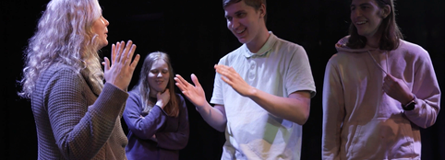 Fyra personer agerar på en scen. 