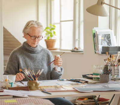 ALMA laureate Eva Lindström at work. Sitting at her desk in a light room.