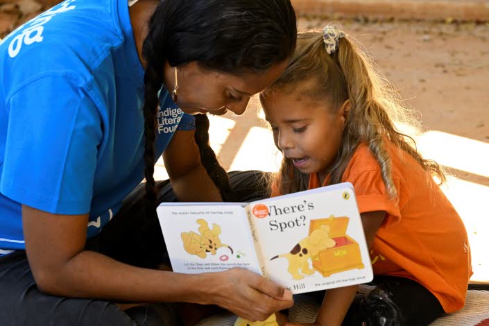 Woman reading for a young child