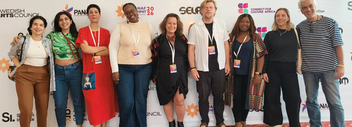 Group photo of smiling partners, Programme for Artistic Freedom.