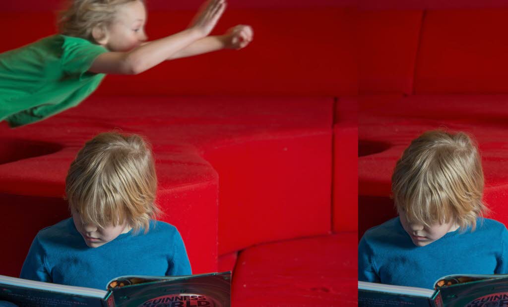 Ett läsande och ett flygande barn i bakgrunden