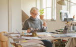 ALMA laureate Eva Lindström at work. Sitting at her desk in a light room.