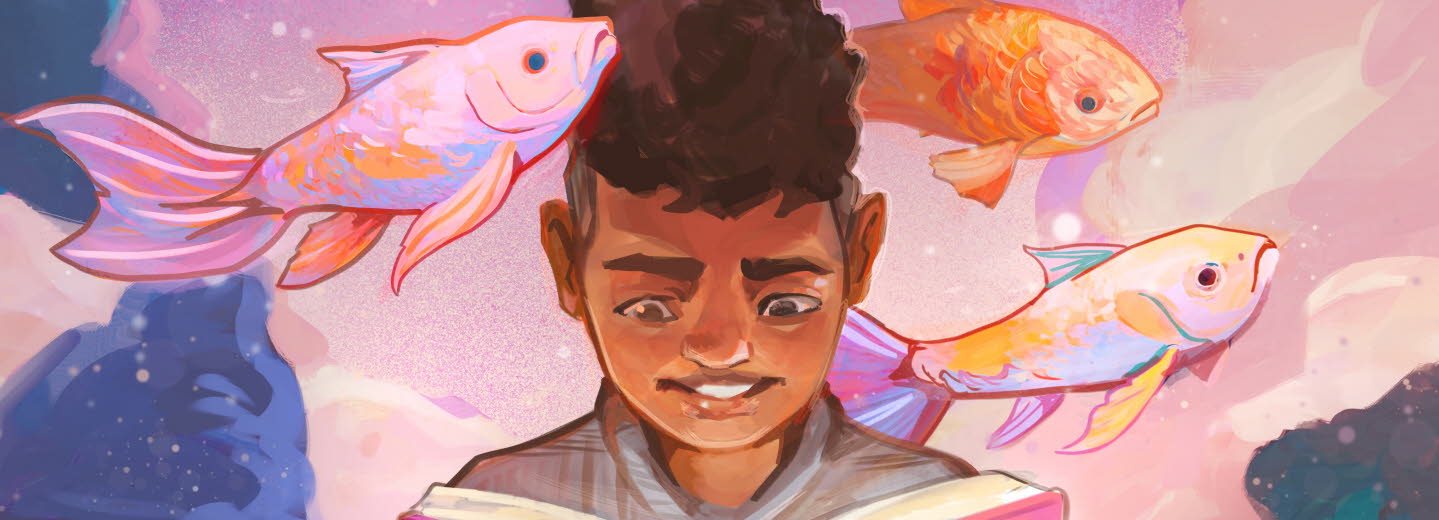 Pojke läser bok om fiskar.