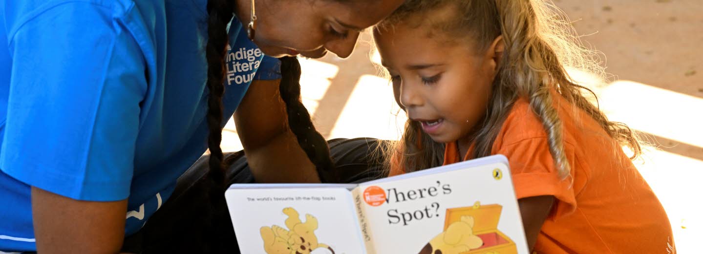 Woman reading for a young child