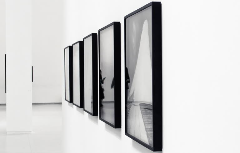 Svartvita fotografier på ett galleri.