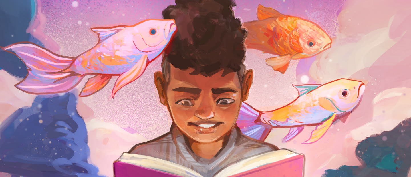 Pojke läser bok om fiskar.