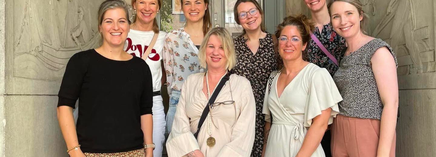 Group photo of eight women standing outside.