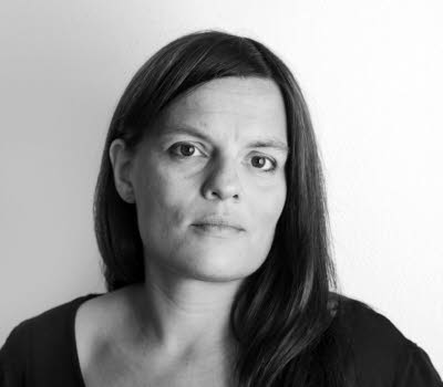 Portrait of Kristina Lindquist, it's black and white and she's looking towards the camera.