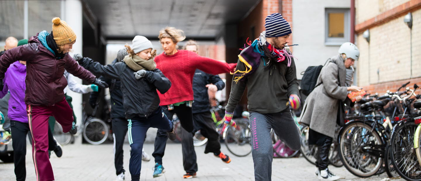 A group of dancers dancing outdoors.