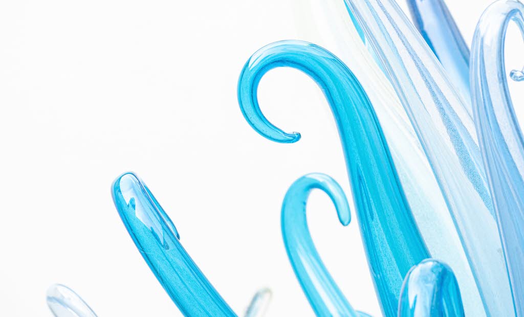 Konstglas i blånyanser formar en bukett av spiror med böjd topp.