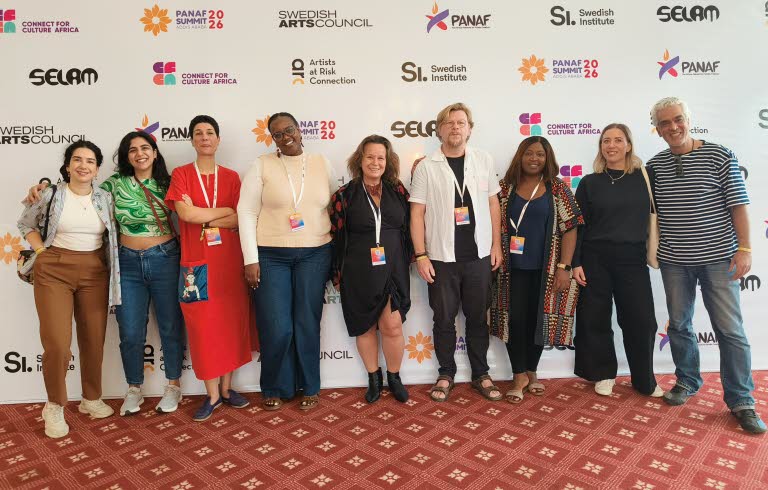 Group photo of smiling partners, Programme for Artistic Freedom.
