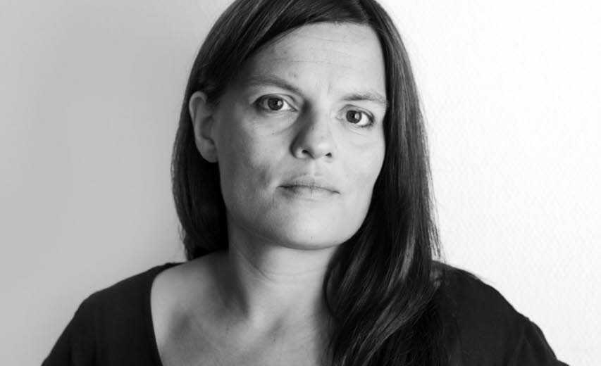 Portrait of Kristina Lindquist, it's black and white and she's looking towards the camera.