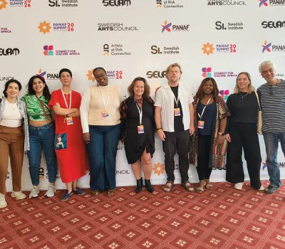 Group photo of smiling partners, Programme for Artistic Freedom. 