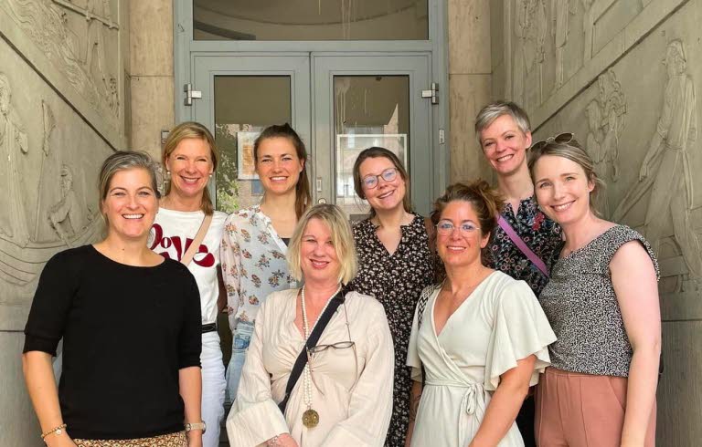 Group photo of eight women standing outside.