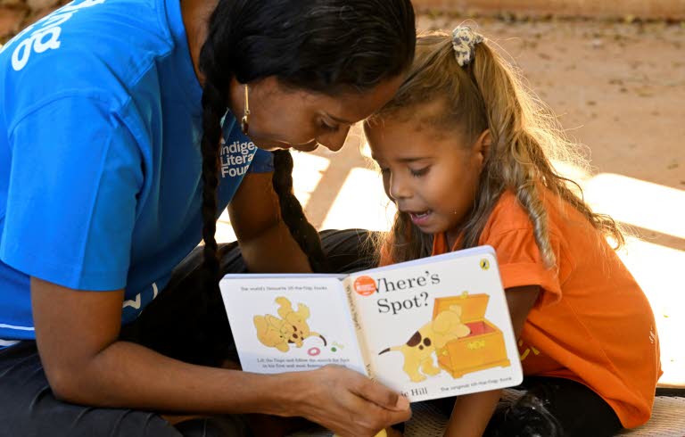 Woman reading for a young child