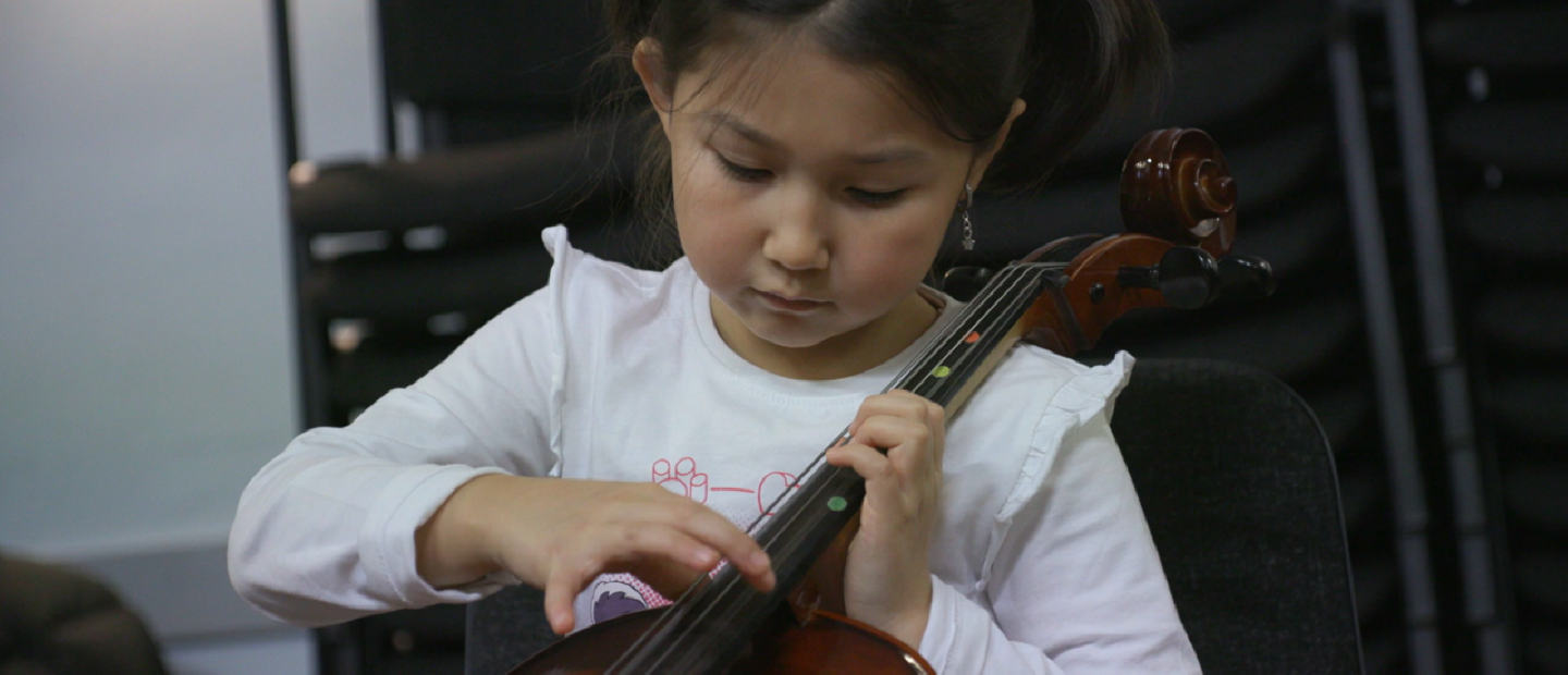 Flicka spelar fiol.