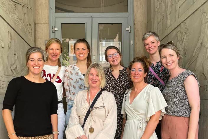 Group photo of eight women standing outside. 
