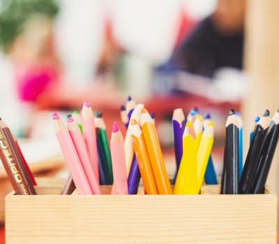 Närbild på ett pennställ innehållandes pennor för barn.