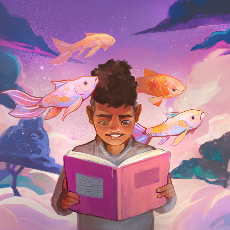 Pojke läser bok om fiskar.