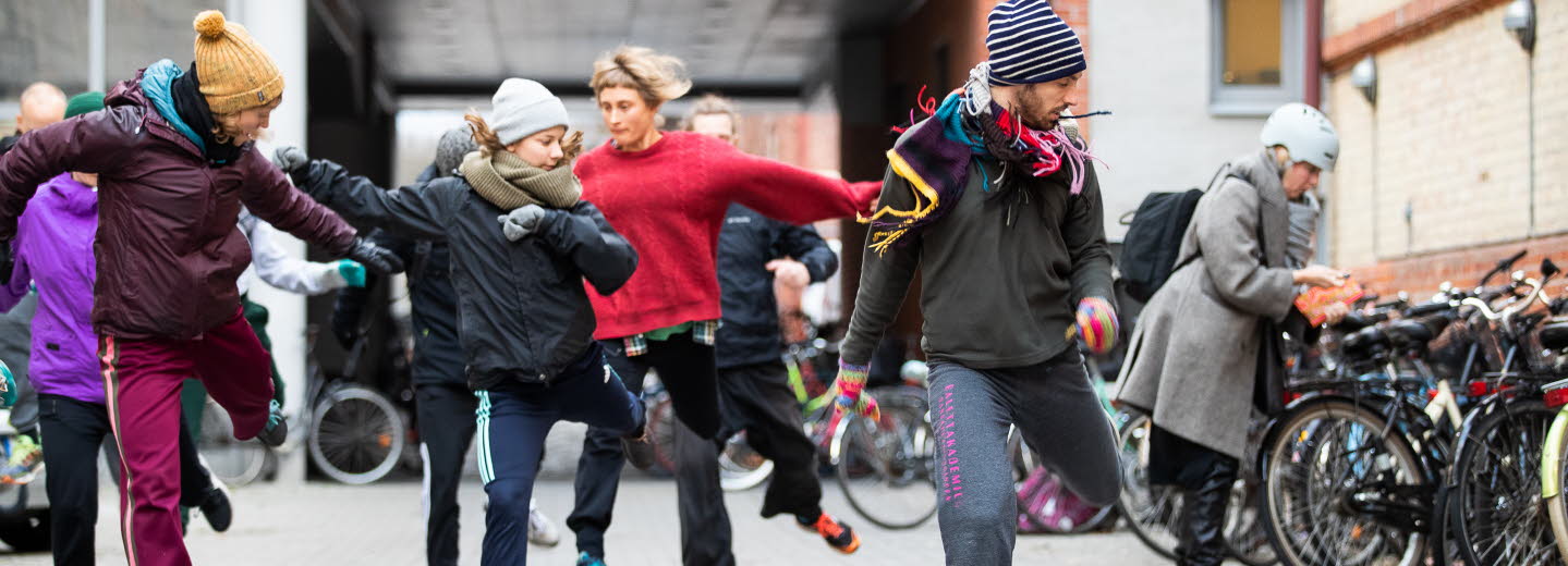 A group of dancers dancing outdoors.